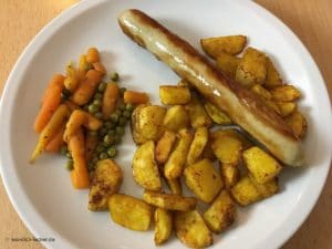 Geflügelbratwurst, Kartoffelspalten mit Erbsen und Möhren