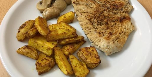 Putenschnitzel mit Kartoffelspalten und Champignons